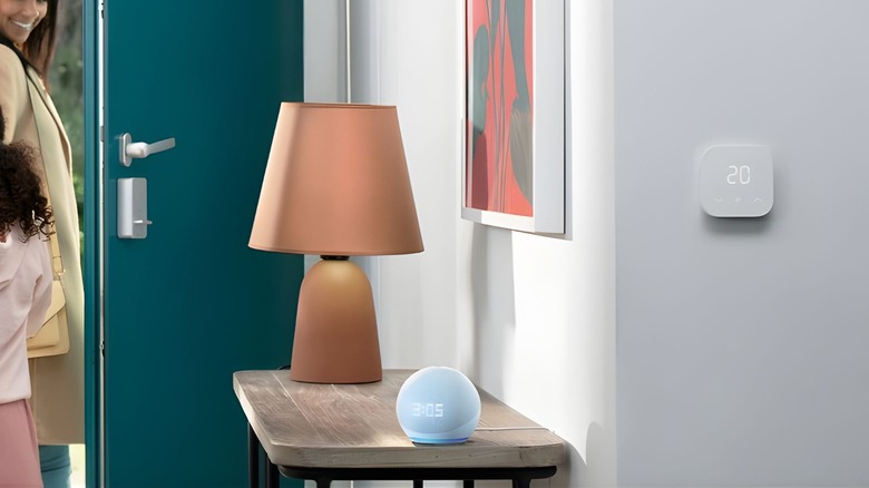 Echo Dot in white on a side table near a front door.