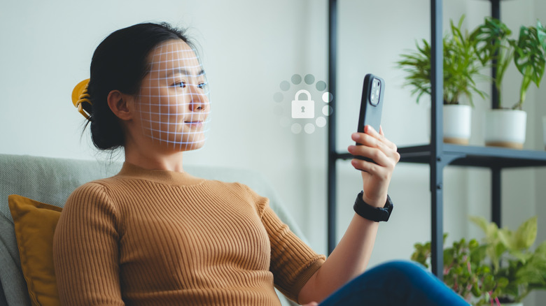 woman using face ID / face unlock tech with smartphone