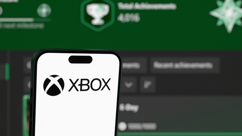 Xbox app on a photo with the logo over a blurred Xbox profile
