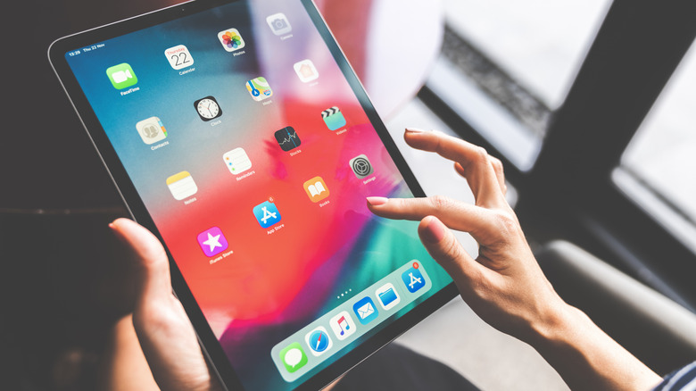 A woman swiping on her iPad
