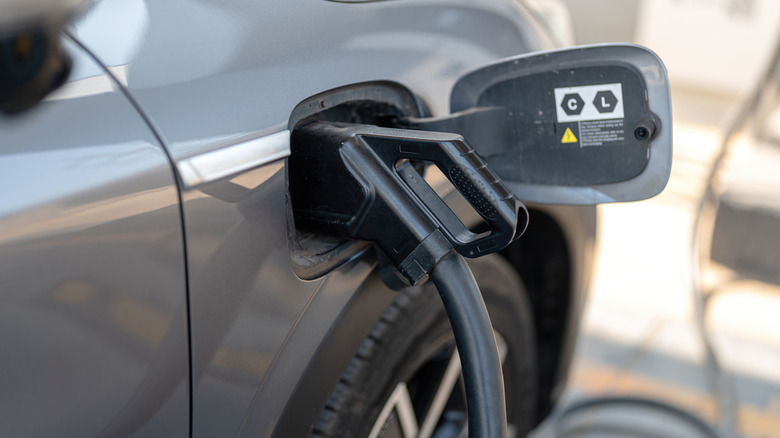 DC fast charging connector plugged into an electric vehicle charging port