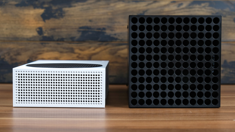 Xbox Series S and Xbox Series X consoles side by side on a wooden surface.