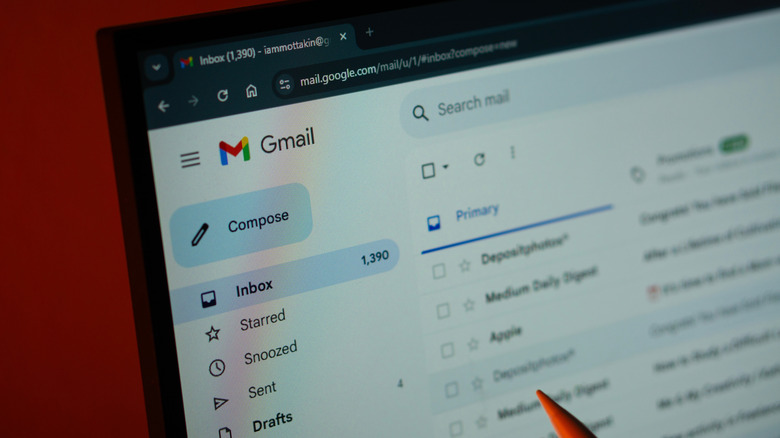 Laptop screen showing a gmail inbox with several unread emails