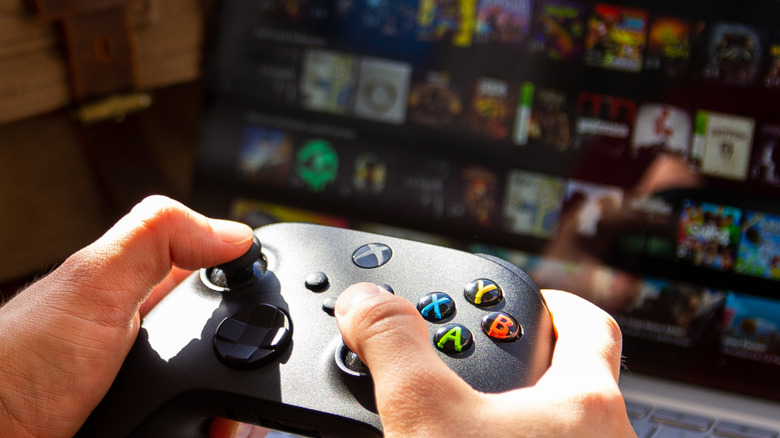 person holding an xbox controller to play games on a chromebook