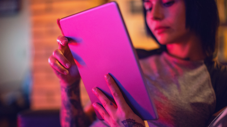 Woman reading on tablet