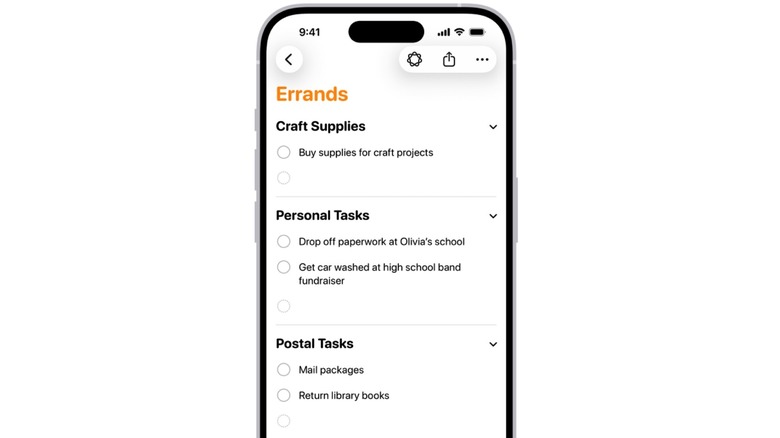 Using Apple Intelligence to auto-categorize reminders in a list in the Reminders app.