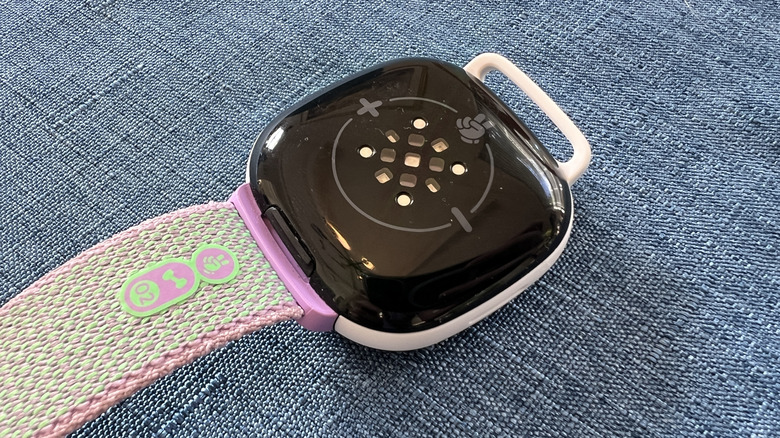 The underside of a Fitbit Ace showing the contacts.