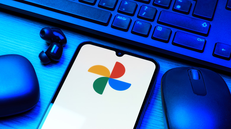 Google Photos logo on phone with other electronics