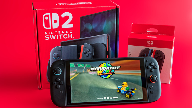a Nintendo Switch 2 box with an accessory, console, and Mario Kart World game on display