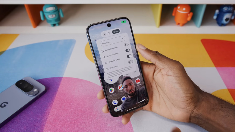 Hand holding Android showing Android 17 sefie video in screen recording