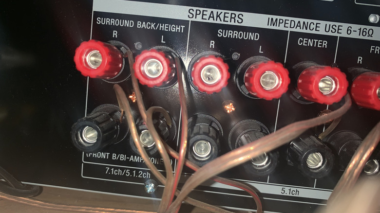 An AV receiver's speaker terminals, with a dedicated bi-amp bank of channels.
