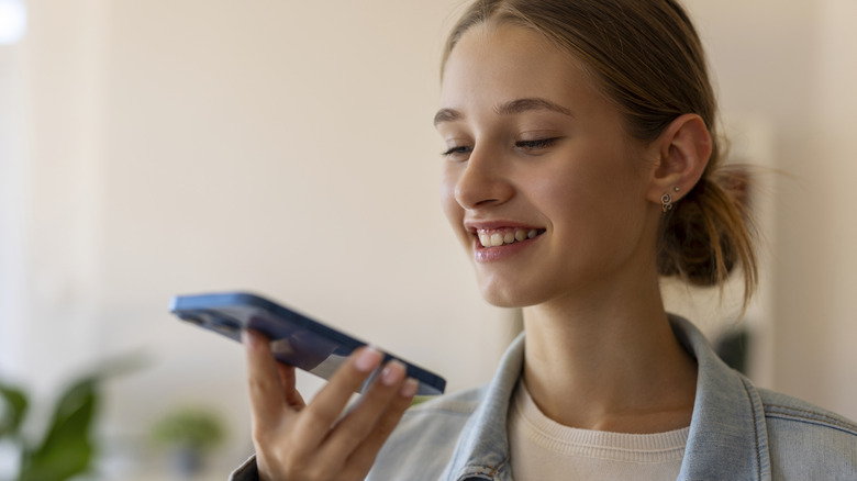 Young woman talking to iPhone