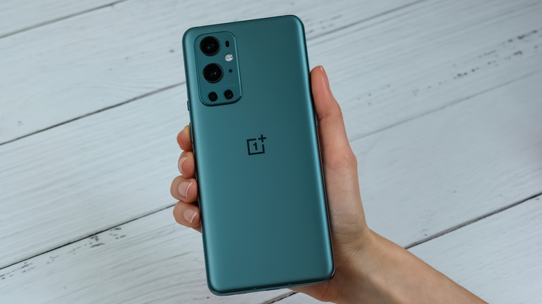 Person holding OnePlus 9 Pro smartphone