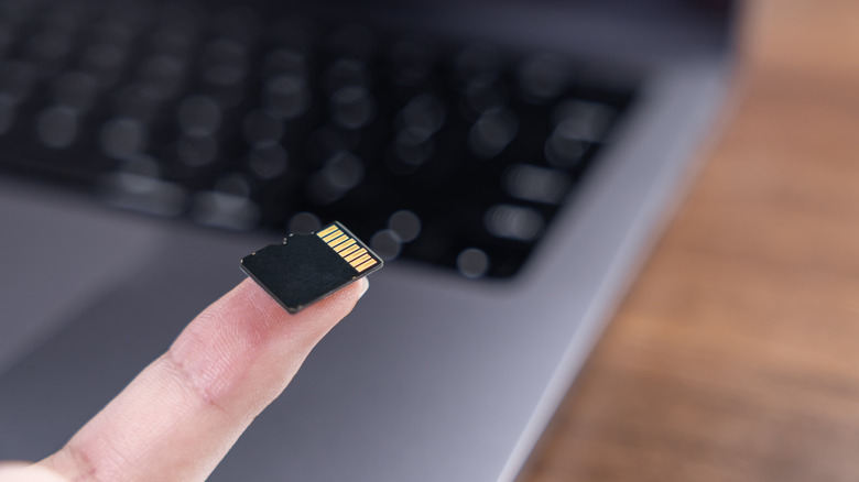 MicroSD card being held on a finger