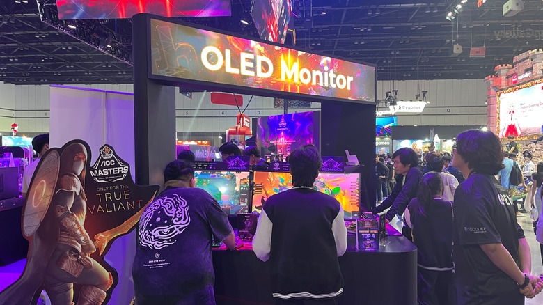 Gamers playing video games on OLED monitors in Thailand Game Show