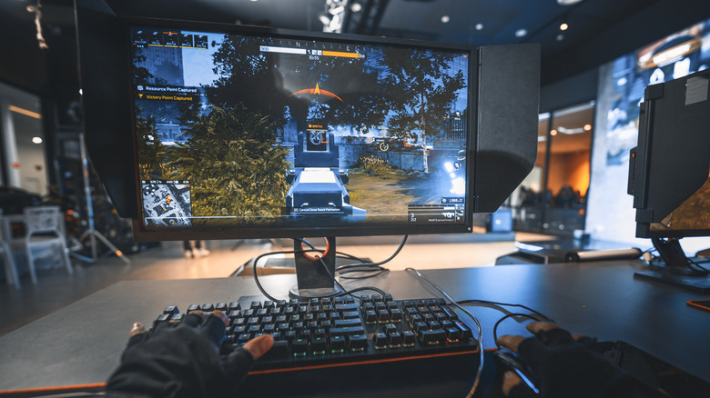 A person playing an RPG strategy video game on a computer