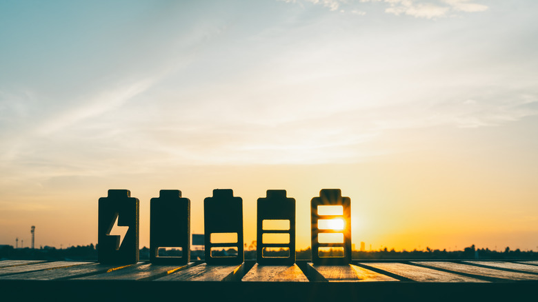 Cutouts of various battery levels depicting charging levels against a sunny background
