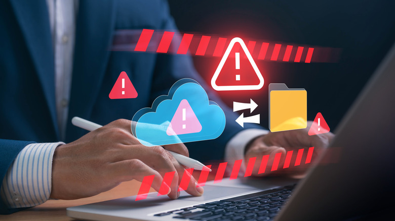 An illustration showing cloud storage warning alerts as a person works on a laptop