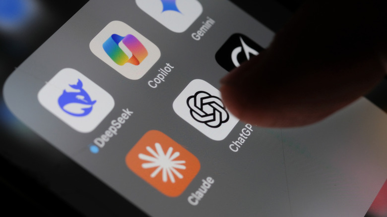 Finger hovering over ChatGPT among AI app icons on a smartphone screen.