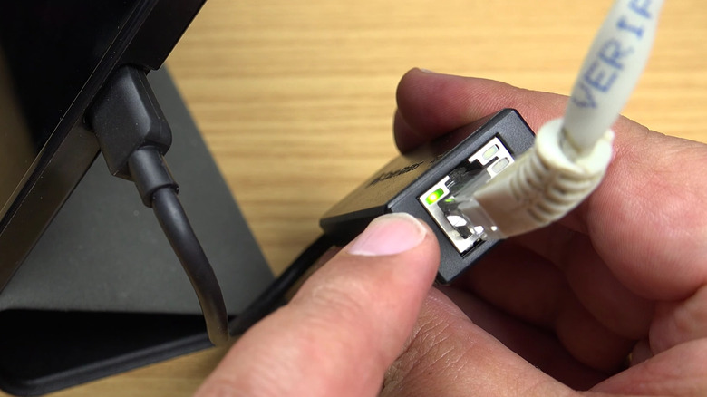 A LAN cable connected to a Samsung tablet using a USB-C-to-HDMI connector