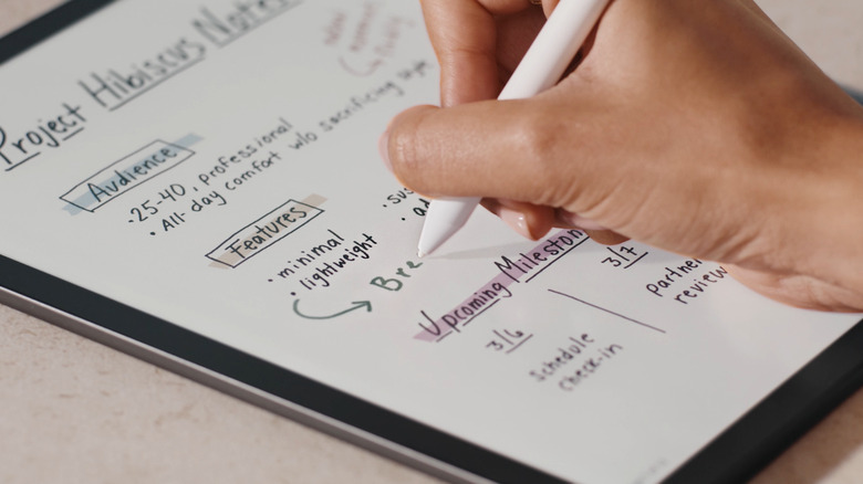 Kindle Scribe Colorsoft with hand writing with stylus on screen