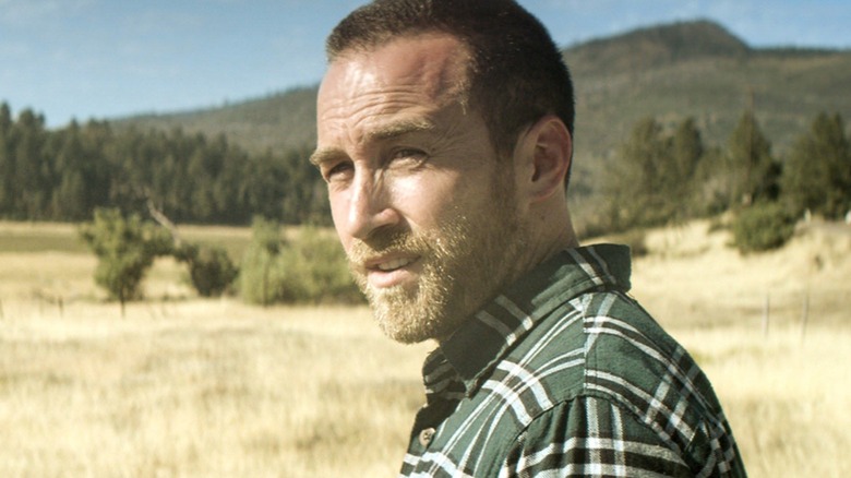 Aaron standing in a dry field in "The Endless."