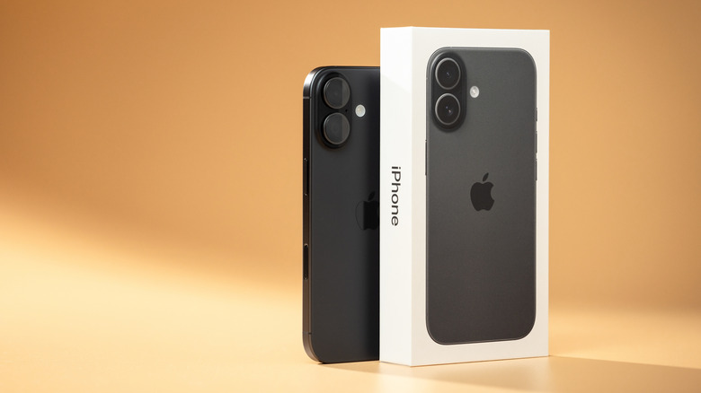 iphone 17 along with its packaging box against a warm background