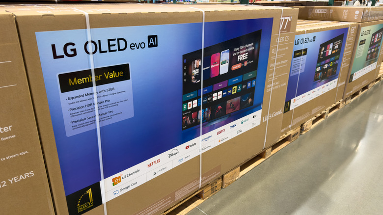 LG OLED evo AI TV inside its box on a wooden pallet in a store