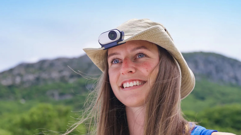Insta360 Go 3S mounted on hat clip worn by woman