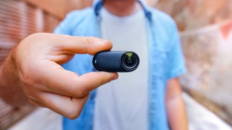 Hand holding Insta360 Go 3S in landscape mode