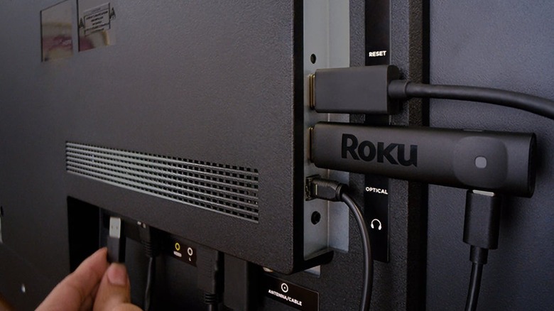 Roku Streaming Stick Plus connected to back of TV