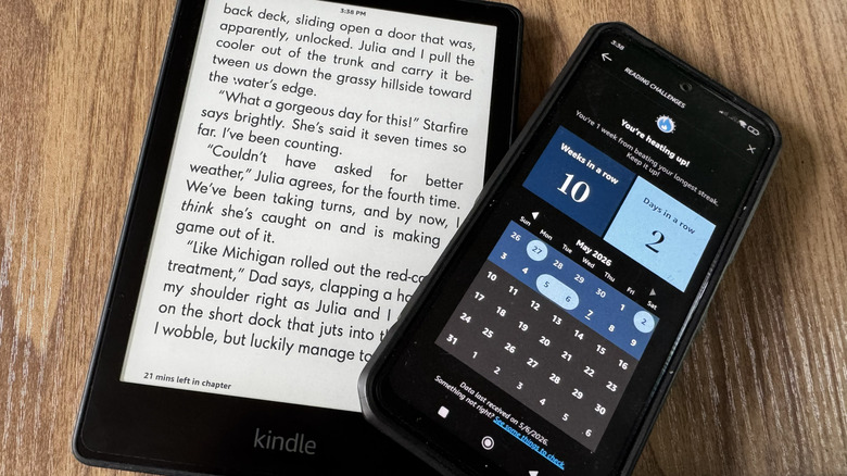 A Kindle placed under a phone showing Kindle streaks