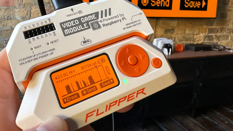 The Flipper Zero with the Video Game Module attached and connected to a TV.
