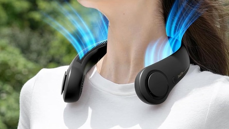 A woman wearing a Jisulife portable neck fan.