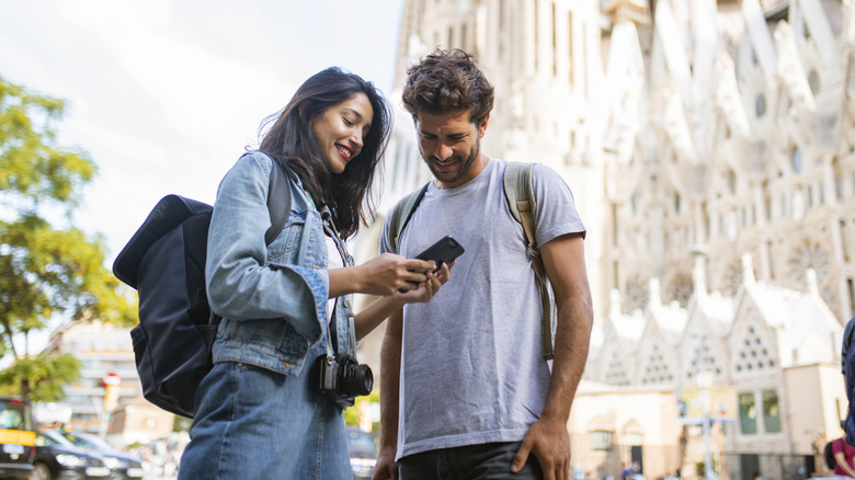 A low angle shot of a couple sightseeing in Barcelona