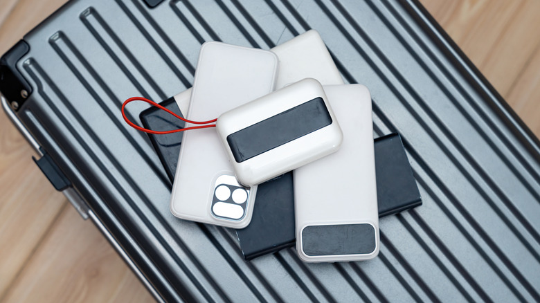 A bunch of gadgets on a luggage