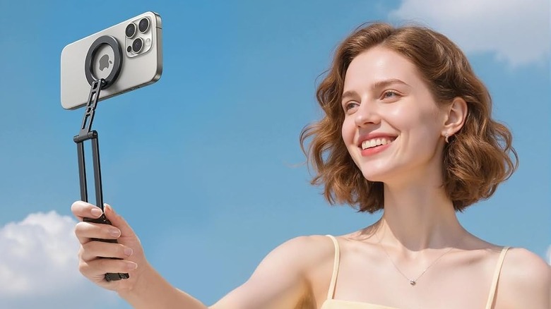 Close-up of a person using Lamicall for MagSafe Tripod Stand as a selfie stick