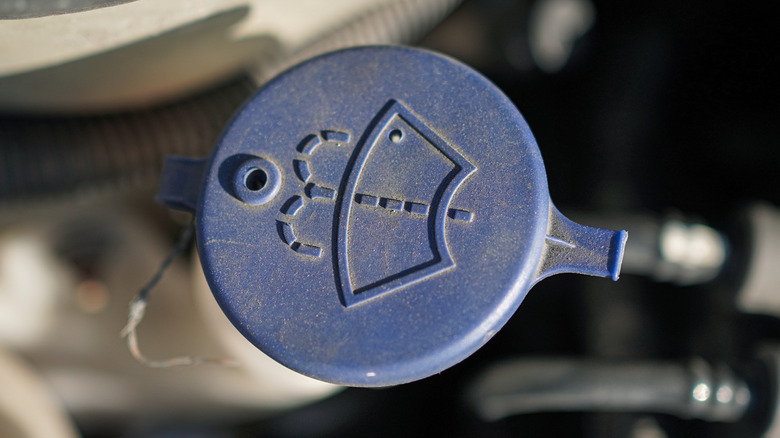 The wiper fluid reservoir cap in a car.