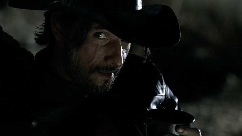 Hector Escaton holding a cup in Westworld.