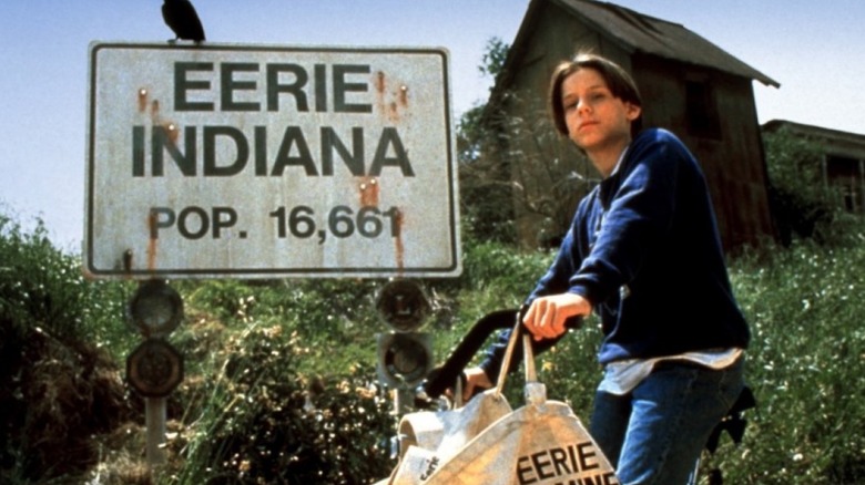 Marshall Teller (Omri Katz) on a bike by a road sign in Eerie, Indiana