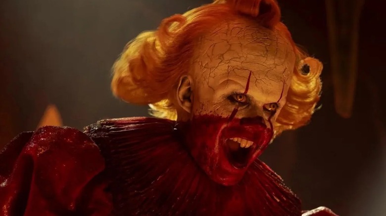 Bill Skarsgård as Pennywise covered in blood in IT: Welcome to Derry