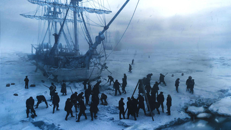 A group of men standing on ice next to a grounded ship in "The Terror."