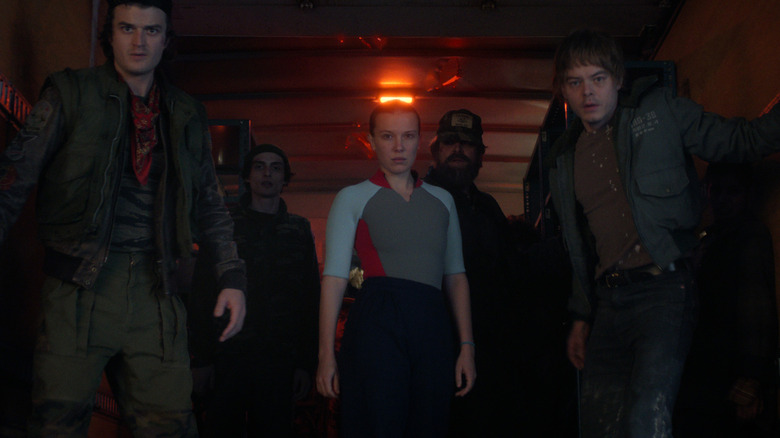 Characters from Stranger Things looking at something together.