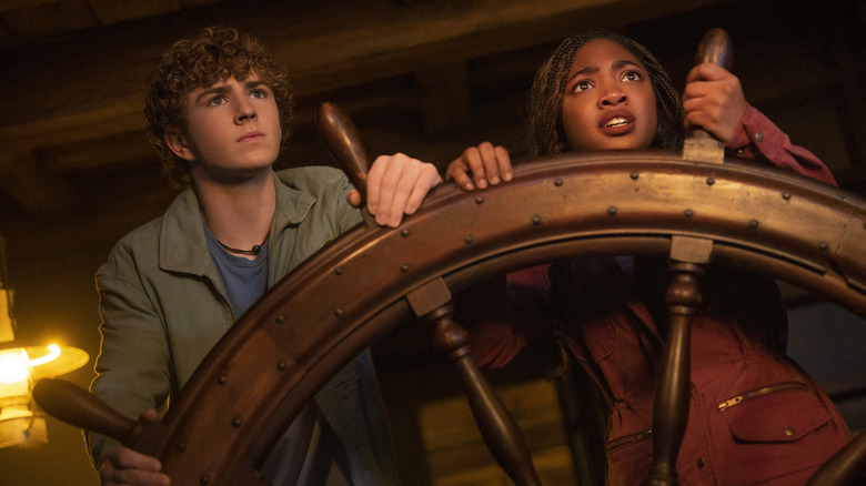 Percy and Annabeth turning the big wheel of a ship in Percy Jackson and the Olympians.