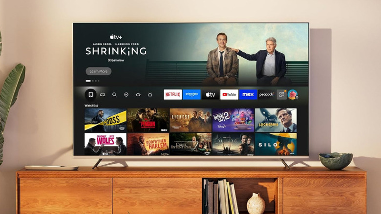 Hisense U65QF smart TV placed on a console