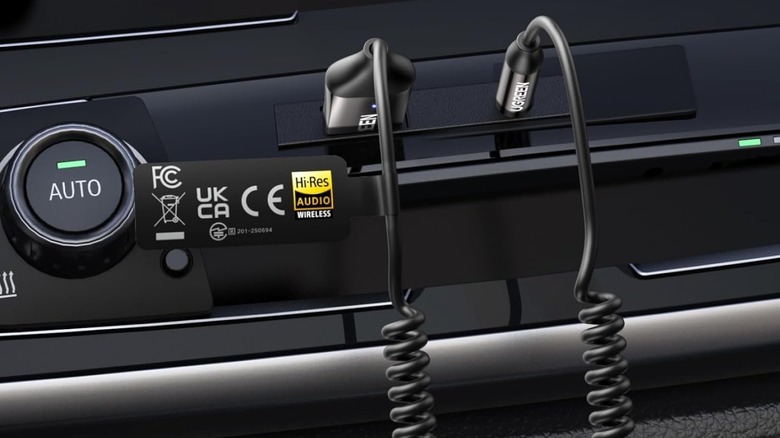 UGREEN Aux to Bluetooth 6.0 Adapter with LDAC plugged into a car's infotainment system