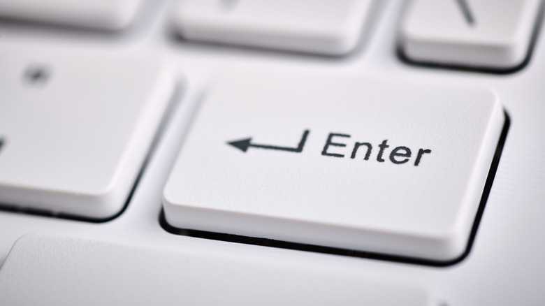 Close up of the enter key on an ultra thin laptop