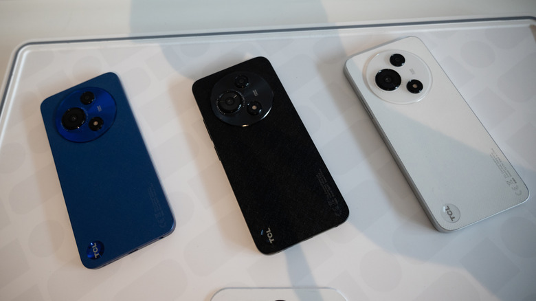 Three TCL smartphones placed on a table