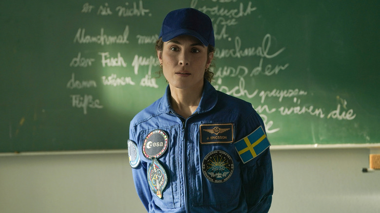 Jo standing in front of a chalkboard in "Constellation."