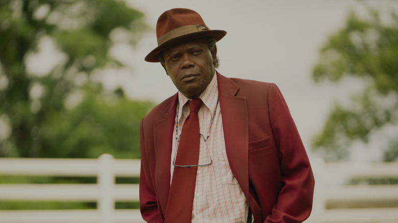Ptolemy Grey frowning and wearing a red suit in "The Last Days of Ptolemy Grey."
